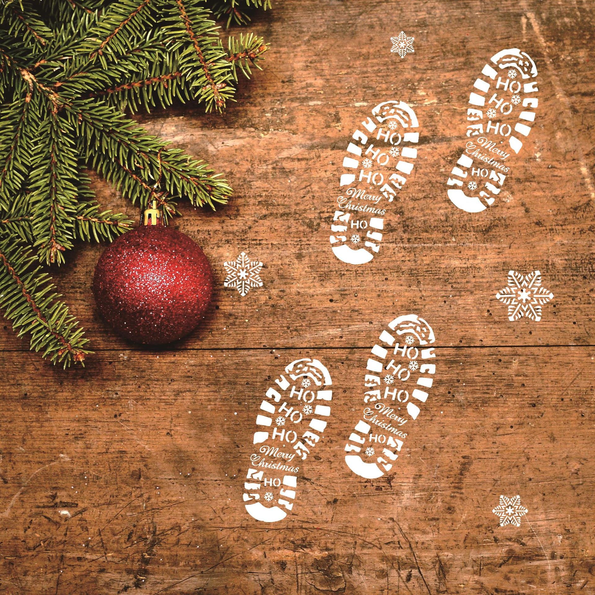 White plastic stencil for dusting Christmas boot prints along a trail