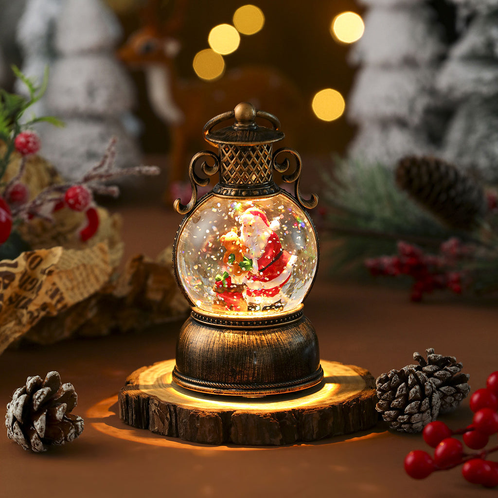 Musical Christmas snow globe lantern with a lit resin scene inside