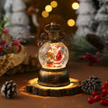 Musical Christmas snow globe lantern with a lit resin scene inside