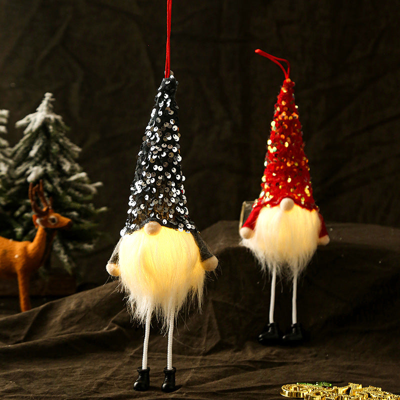Dark green faceless gnome doll covered entirely in sequinned cloth